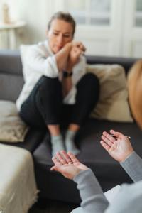 Woman on couch crying. Therapist's Guide